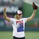 Olympic gold-medal swimmer Katie Ledecky reacts after she threw out the ceremonial first pitch before a baseball game between the Baltimore Orioles and the Washington Nationals, Wednesday, Aug. 24, 2016, in Washington. (AP Photo/Nick Wass)