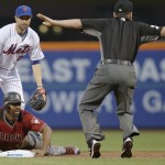 New York Mets second baseman Neil Walker, top left, watches as second base umpire D.J. Reyburn rules Arizona Diamondbacks Michael Bourn safe at second on a pick-off attempt during the first inning of a baseball game Wednesday, Aug. 10, 2016, in New York. (AP Photo/Kathy Willens)