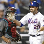 New York Mets Neil Walker (20) smiles in front of Arizona Diamondbacks catcher Tuffy Gosewisch after hitting a two-run home run during the sixth inning of a baseball game, Tuesday, Aug. 9, 2016, in New York. (AP Photo/Kathy Willens)