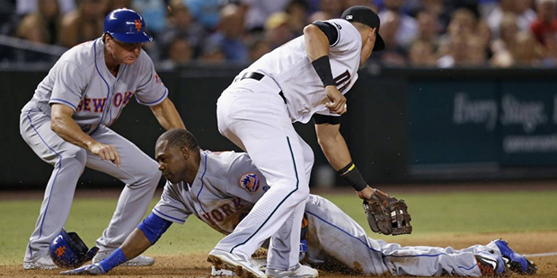 New York Mets' Alejandro De Aza slides safely into third base as Arizona Diamondbacks' Jake Lamb, r...