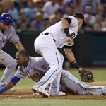 New York Mets' Alejandro De Aza slides safely into third base as Arizona Diamondbacks' Jake Lamb, right, applies a late tag as Mets third base coach Tim Teufel watches during the sixth inning of a baseball game Tuesday, Aug. 16, 2016, in Phoenix. De Aza hit an RBI double and reached third base on an error by the Diamondbacks. (AP Photo/Ross D. Franklin)