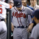 Atlanta Braves' Freddie Freeman walks slowly back to the field after he fell over a railing trying in vain to make a catch on a foul ball during the second inning of a baseball game against the Arizona Diamondbacks Thursday, Aug. 25, 2016, in Phoenix. (AP Photo/Ross D. Franklin)