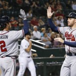 Atlanta Braves' Freddie Freeman, right, and Dansby Swanson (2) celebrate as both scored against the Arizona Diamondbacks during the eighth inning of a baseball game Tuesday, Aug. 23, 2016, in Phoenix. (AP Photo/Ross D. Franklin)