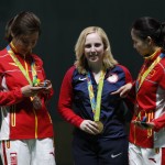 Gold medal winner, Virginia Thrasher of the United States, center, poses for a picture with silver medal winner, Du li of China, left, and bronze medalist China's Yi Siling, during the victory ceremony for the Women's 10m Air Rifle event at Olympic Shooting Center at the 2016 Summer Olympics in Rio de Janeiro, Brazil, Saturday, Aug. 6, 2016. (AP Photo/Hassan Ammar)