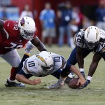 San Diego Chargers quarterback Kellen Clemens, center, dives for a loose ball as running back Melvin Gordon, right, and Arizona Cardinals offensive tackle Olsen Pierre reach for it during the first half of a preseason NFL football game, Friday, Aug. 19, 2016, in San Diego. (AP Photo/Rick Scuteri)