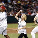 Olympics medalists Rogers Kingdom, left, who represented the United States, Olga Korbut, middle, who represented the Soviet Union, and Misty Hyman, right, who represented the United States, throw out the first pitches on Pass the Torch Night prior to a baseball game between the Arizona Diamondbacks and the Milwaukee Brewers Friday, Aug. 5, 2016, in Phoenix. (AP Photo/Ross D. Franklin)