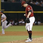 Arizona Diamondbacks' Zack Godley (52) pauses on the mound after giving up a home run to Daniel Murphy, second from left, as Murphy runs past Diamondbacks' Jake Lamb, left, during the sixth inning of a baseball game Wednesday, Aug. 3, 2016, in Phoenix. (AP Photo/Ross D. Franklin)