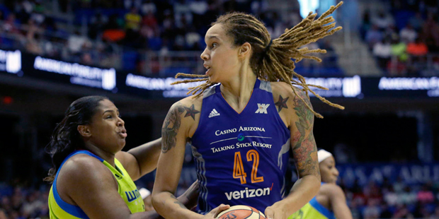 Phoenix Mercury center Brittney Griner (42) is defended by Dallas Wings center Courtney Paris durin...