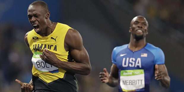Usain Bolt from Jamaica, left, celebrates winning the gold medal in the men's 200-meter final durin...