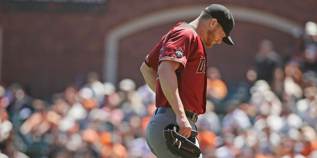 Arizona Diamondbacks starting pitcher Shelby Miller walks back to the dugout after throwing in the ...