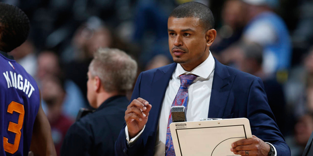 Phoenix Suns coach Earl Watson grabs a clipboard to draw a play as he calls for a timeout during th...