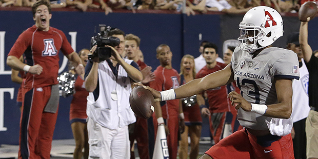 Arizona quarterback Brandon Dawkins scores a first half touchdown during an NCAA college football g...