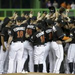 Miami Marlins players wearing a jersey in honor of pitcher Jose Fernandez (16) gather around the pitching mound before a baseball game against the New York Mets, Monday, Sept. 26, 2016, in Miami. Fernandez died in a boating accident Sunday. (AP Photo/Lynne Sladky)