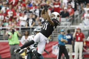 Arizona Cardinals' Larry Fitzgerald (11) makes a jumping touchdown catch in front of Philadelphia Eagles' Nnamdi Asomugha in the first half of an NFL football game on Sunday, Sept. 23, 2012, in Glendale, Ariz. (AP Photo/Rick Scuteri)