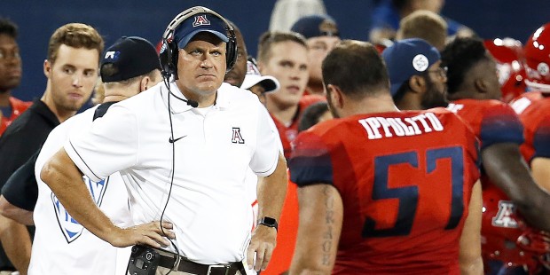 Arizona coach Rich Rodriguez stares down Cody Ippolito (57) after Ippolito was ejected from the NCA...
