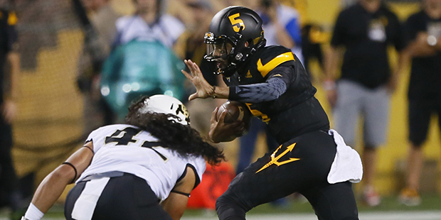 Arizona State quarterback Manny Wilkins (5) runs the ball during the second half of an NCAA college...