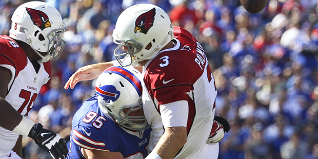 Arizona Cardinals quarterback Carson Palmer (3) is hit by Buffalo Bills defensive end Kyle Williams...