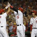Washington Nationals' Anthony Rendon (6) celebrates his three run home run with Wilmer Difo, center, and Trea Turner, right, during the sixth inning of a baseball game against the Arizona Diamondbacks, Tuesday, Sept. 27, 2016, in Washington. (AP Photo/Nick Wass)