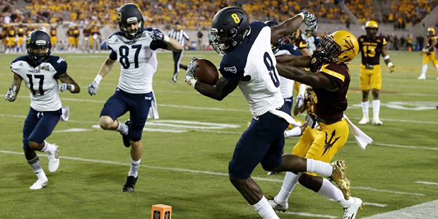 Arizona State's De'Chavon Hayes, right, shoves Northern Arizona's Emmanuel Butler (8) out of bounds...