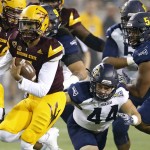 Arizona State's Manny Wilkins, left, runs past Northern Arizona's Jake Thomas (44) and Lorenzo Melvin (54) for a first down during the first half of an NCAA college football game Saturday, Sept. 3, 2016, in Tempe, Ariz. (AP Photo/Ross D. Franklin)