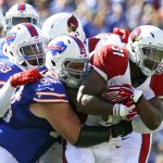 Arizona Cardinals running back David Johnson (31) is stopped by Buffalo Bills defenders Kyle Williams (95) and Zach Brown (53) during the second half of an NFL football game on Sunday, Sept. 25, 2016, in Orchard Park, N.Y. (AP Photo/Bill Wippert)
