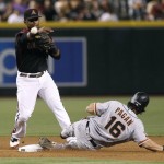Arizona Diamondbacks second baseman Jean Segura, left, throws to first over San Francisco Giants' Angel Pagan to complete a double play on a ball hit by Buster Posey during the fourth inning of a baseball game, Saturday, Sept. 10, 2016, in Phoenix. (AP Photo/Ralph Freso)