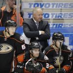 Anaheim Ducks coach Randy Carlyle, center, watches from the bench during the team's NHL preseason hockey game against the Arizona Coyotes, Tuesday, Sept. 27, 2016, in Anaheim, Calif. The Coyotes won 2-1. (AP Photo/Jae C. Hong)