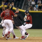 Arizona Diamondbacks' Brandon Drury, right, is surrounded by Yasmany Tomas (24) and teammates after his game winning RBI single against the Los Angeles Dodgers during the 12th inning of a baseball game, Sunday, Sept. 18, 2016, in Phoenix. The Diamondbacks defeated the Dodgers 10-9. (AP Photo/Ralph Freso)
