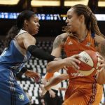Phoenix Mercury's Brittney Griner, right, keeps the ball away as Minnesota Lynx's Maya Moore defends in the first quarter of a WNBA playoff semi-finals basketball game Wednesday, Sept. 28, 2016, in St. Paul, Minn. (AP Photo/Jim Mone)