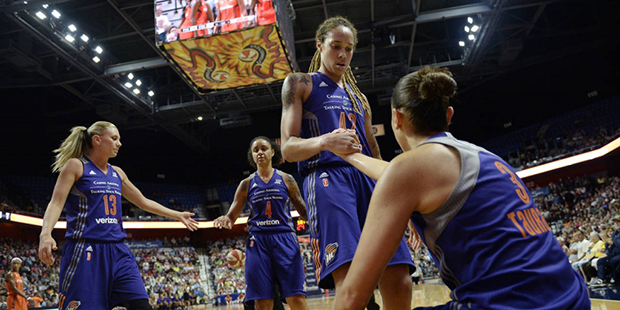 Phoenix Mercury's Brittney Griner helps teammate Diana Taurasi up off the court during the first ha...