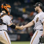 San Francisco Giants' Hunter Strickland, right, is congratulated by catcher Buster Posey after pitching the ninth inning for a save in a victory over the Arizona Diamondbacks during a baseball game, Sunday, Sept. 11, 2016, in Phoenix. (AP Photo/Ralph Freso)