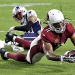 Arizona Cardinals wide receiver Larry Fitzgerald (11) scores a touchdown as New England Patriots cornerback Logan Ryan (26) defends during the first half of an NFL football game, Sunday, Sept. 11, 2016, in Glendale, Ariz. (AP Photo/Rick Scuteri)