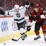 Arizona Coyotes' Kyle Wood (65) battles with Los Angeles Kings' Matt Luff (64) for the puck during the first period of an NHL rookies hockey game Tuesday, Sept. 20, 2016, in Glendale, Ariz. (AP Photo/Ross D. Franklin)