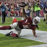 Arizona Cardinals wide receiver Larry Fitzgerald (11) catches his career 100th touchdown pass during the second half of an NFL football game against the New England Patriots, Sunday, Sept. 11, 2016, in Glendale, Ariz. (AP Photo/Rick Scuteri)