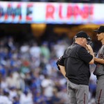 Arizona Diamondbacks starting pitcher Zack Greinke, right, talks with pitching coach Mike Butcher after giving up a three-run home run to Los Angeles Dodgers' Corey Seager during the fifth inning of a baseball game, Monday, Sept. 5, 2016, in Los Angeles. (AP Photo/Mark J. Terrill)