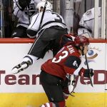 Arizona Coyotes' Conor Garland (83) avoids the check by Los Angeles Kings' Brayden McNabb (3) during the third period of a preseason NHL hockey game Monday, Sept. 26, 2016, in Glendale, Ariz. The Coyotes defeated the Kings 5-3. (AP Photo/Ross D. Franklin)