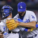 Los Angeles Dodgers' Kenley Jansen, right, hugs catcher Carlos Ruiz, left, after the final out of the ninth inning of a baseball game against the Arizona Diamondbacks Saturday, Sept. 17, 2016, in Phoenix. The Dodgers defeated the Diamondbacks 6-2. (AP Photo/Ross D. Franklin)