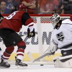 Los Angeles Kings' Peter Budaj, right, gives up a goal to Arizona Coyotes' Luke Schenn as Coyotes' Christian Dvorak (18) and Kings' Derek Forbort (24) watch during the first period of a preseason NHL hockey game Monday, Sept. 26, 2016, in Glendale, Ariz. (AP Photo/Ross D. Franklin)