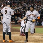 San Francisco Giants' Hunter Pence, right, is congratulated by Brandon Belt (9) after hitting a solo home run against the Arizona Diamondbacks during the seventh inning of a baseball game, Saturday, Sept. 10, 2016, in Phoenix. (AP Photo/Ralph Freso)