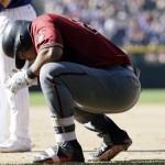 Arizona Diamondbacks' Yasmany Tomas reacts after injuring himself while running to first base following his single off Colorado Rockies starting pitcher Jon Gray in the seventh inning of a baseball game Sunday, Sept. 4, 2016, in Denver. Tomas left the game. (AP Photo/David Zalubowski)