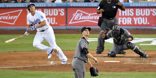 Los Angeles Dodgers' Corey Seager watches his three-run home run, along with Arizona Diamondbacks s...