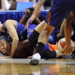 Connecticut Sun's Alyssa Thomas, bottom, looks toward the ball after Phoenix Mercury's Diana Taurasi, top, passes it to teammate Candice Dupree, right, as both fall on the court during the second half of a WNBA basketball game, Friday, Sept. 2, 2016, in Uncasville, Conn. (AP Photo/Jessica Hill)
