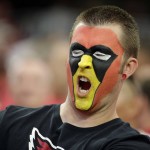 An Arizona Cardinals fan watches prior to an NFL football game against the New England Patriots, Sunday, Sept. 11, 2016, in Glendale, Ariz. (AP Photo/Rick Scuteri)