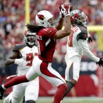 Arizona Cardinals wide receiver Larry Fitzgerald (11) pulls in a pass as Tampa Bay Buccaneers cornerback Vernon Hargreaves (28) and defensive end Robert Ayers (91) defend during the first half of an NFL football game, Sunday, Sept. 18, 2016, in Glendale, Ariz. (AP Photo/Ross D. Franklin)