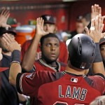 Arizona Diamondbacks' Jake Lamb, front right, celebrates his run scored against the Colorado Rockies with teammates, including pitcher Rubby De La Rosa, middle, during the first inning of a baseball game Wednesday, Sept. 14, 2016, in Phoenix. (AP Photo/Ross D. Franklin)