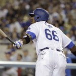 Los Angeles Dodgers' Yasiel Puig watches after hitting a sacrifice fly during the first inning of a baseball game against the Arizona Diamondbacks, Wednesday, Sept. 7, 2016, in Los Angeles. (AP Photo/Jae C. Hong)