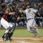 San Francisco Giants' Brandon Crawford, right, slides home to score on a double by teammate Hunter Pence as Arizona Diamondbacks catcher Weligton Castillo waits for the throw to the plate during the seventh inning of a baseball game, Sunday, Sept. 11, 2016, in Phoenix. (AP Photo/Ralph Freso)