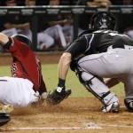Arizona Diamondbacks' Chris Owings, left, scores as he knocks the ball loose from Colorado Rockies catcher Tom Murphy, right, during the fifth inning of a baseball game Wednesday, Sept. 14, 2016, in Phoenix. (AP Photo/Ross D. Franklin)