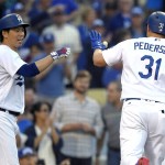 Los Angeles Dodgers' Joc Pederson, right, is congratulated by Kenta Maeda, of Japan, after hitting a solo home run during the fifth inning of a baseball game against the Arizona Diamondbacks, Monday, Sept. 5, 2016, in Los Angeles. (AP Photo/Mark J. Terrill)