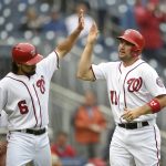 Washington Nationals' Anthony Rendon (6) high-fives Ryan Zimmerman after they both scored on a single by Michael Taylor during the fourth inning of a baseball game against the Arizona Diamondbacks, Thursday, Sept. 29, 2016, in Washington. (AP Photo/Nick Wass)